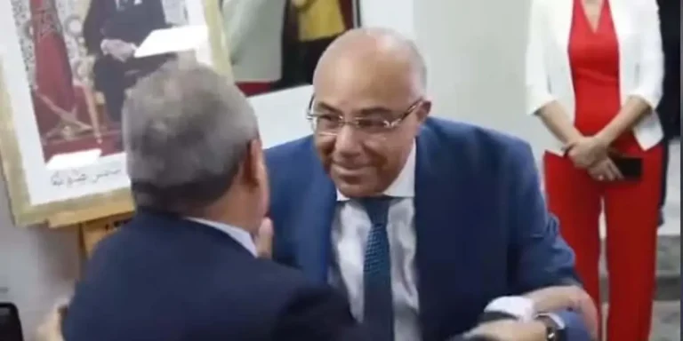 The incomplete embrace during the handover ceremony between Ministers Merawi and Medawi